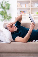 Old man with injured eyes resting at home
