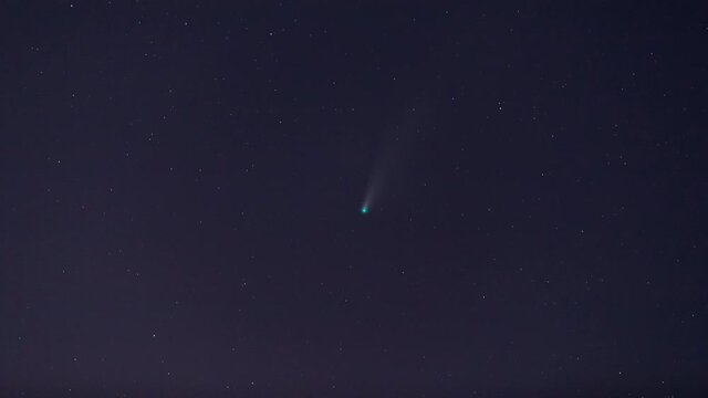 Time lapse of Comet NEOWISE or C/2020 F3 (NEOWISE) with cloud in the night sky.