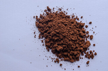 Cool loose coffee on a white background. Brewed coffee. Beautiful pattern. A handful of coffee.