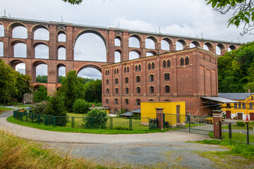 Mylau, Saxony, Germany.  The building of the historic Ketzel flour mill is dwarfed by the arches of...