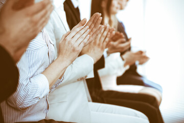 Business people clapping and applause at meeting or conference, close-up of hands. Group of unknown...