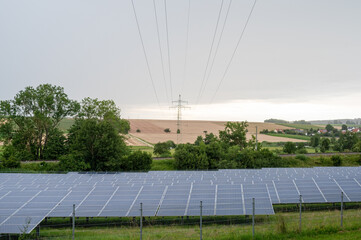 Beautiful sceenery of a little solar park in Bavaria, sourrounded by beautiful landscape in a...
