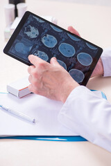 Old male doctor radiologist in telehealth concept