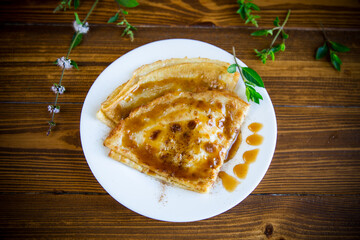 fried thin pancakes with sweet caramel in a plate