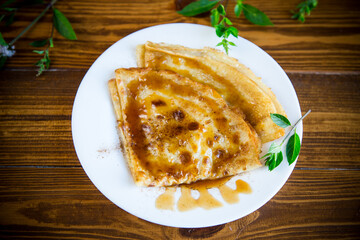 fried thin pancakes with sweet caramel in a plate