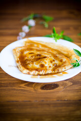 fried thin pancakes with sweet caramel in a plate