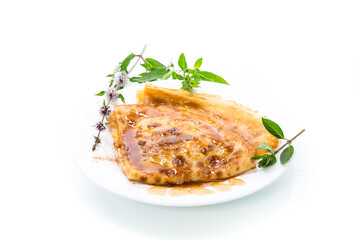 fried thin pancakes with sweet caramel in a plate