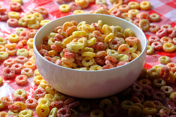 colorful ring corn flakes in a bowl on table cloth 