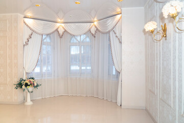 A hall with old rounded windows and elegant interior in soft colors