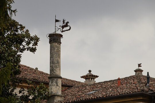 old town roofs with chimey and wind vane