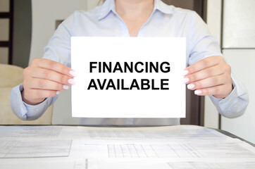 woman holds a tablet with text. text financing available