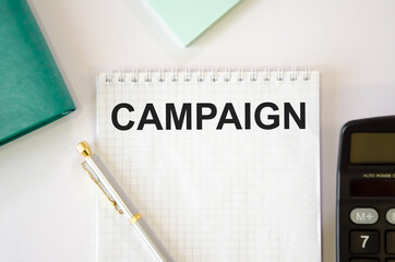 on the notebook is written the text campaign