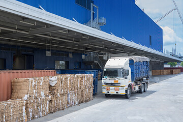 Truck is carrying container parking in front warehouse