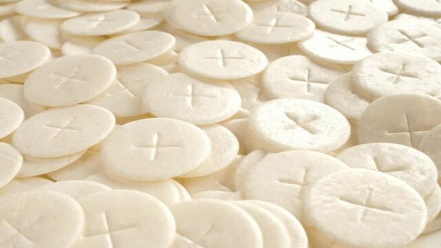 communion hosts sacramental breads turning round rotating flat lay top view