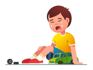 Sad boy kid sitting crying over broken toy car