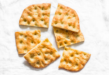 Italian focaccia on a light background, top view. Traditional italian bread