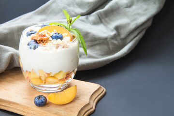 Healthy blueberry, peach and walnut parfait in a glass