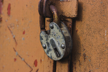 Old rusty lock on an iron door