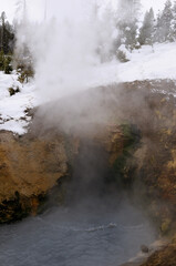 Fototapeta na wymiar Dragons Mouth hot spring in Mud Volcano area of Yellowstone National Park in winter