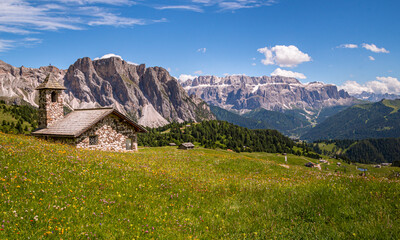 View of mountain chapel infront of Sella group (Sellagruppe, gruppo del sella) from Alp Seceda in Dolomites UNESCO World Heritage in Val Gardena (Gröden), South Tyrol (Südtirol, Alto Adige), Italy