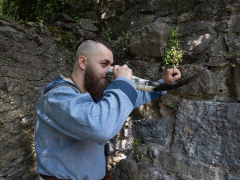 A Viking warrior drinks cider from a horn