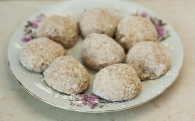 homemade meatballs on the plate in the kitchen - making minced meatballs, traditional Italian cuisine