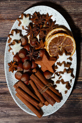 spices and christmas cookies on a dish, top view closeup