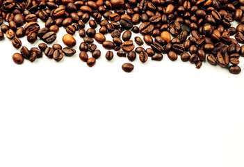 coffee beans scattered on a white background. aromatic arabica on a background with copy space. mockup