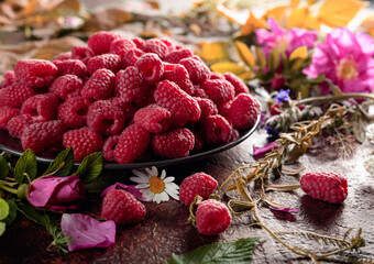 Still life with, raspberries, flowers and meadow grasses.