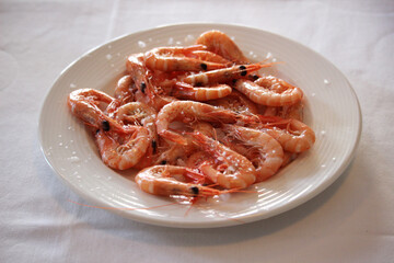 Cooked prawns on a plate with salt 
