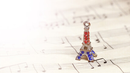 Small bronze of Eiffel tower figurine and music paper