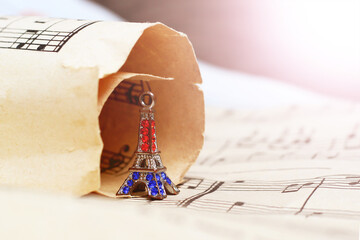Small bronze of Eiffel tower figurine and music paper