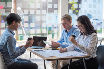 Group of young asian creative people. Mobile application designers and website designers brainstorm and planning project work together.