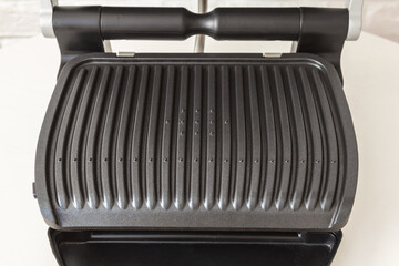 Ridge teflon surface of an electric grill. Close-up view of barbecue for home use. - 368845204