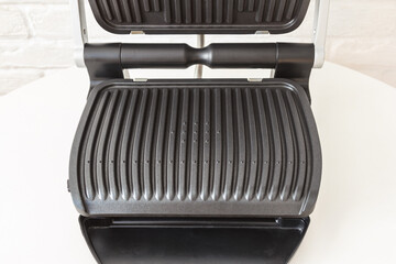 Ridge teflon surface of an electric grill. Close-up view of barbecue for home use. - 368845220
