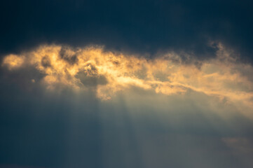 Fototapeta na wymiar Evening clouds and sun rays