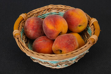 Peach heap in the wooden basket