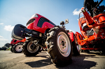 Obraz premium Rows of modern tractors. Industrial details. Agricultural 