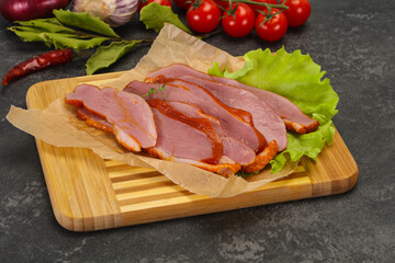 Sliced smoked duck breast served salad