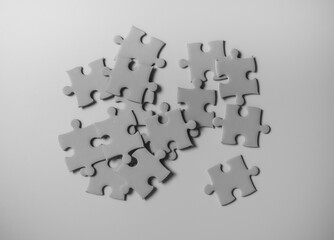 Blank gray puzzle pieces on grey background
