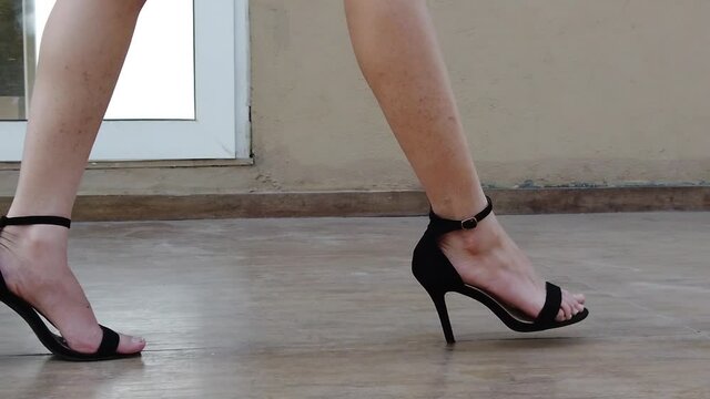 Walking along with a girl in black high heels in slow motion