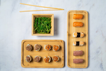 Sushi and Seaweed salad served on bamboo dishes