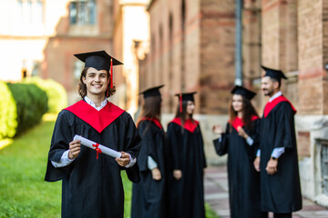 Graduation man in front of a group of graduation students at University