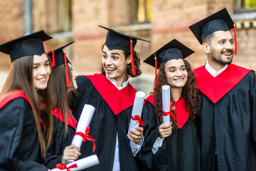 Graduates embrace, enjoy and look at the camera on the graduation ceremony. Happy graduation day. 5...