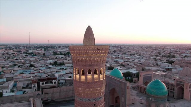 Po-i-Kalyan mosque complex in Bukhara and Kalyan Minaret at sunset, shot by a drone