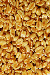 Nuts with honey. Sweet, natural food. Peanuts with bee honey. View up close. Background, texture.