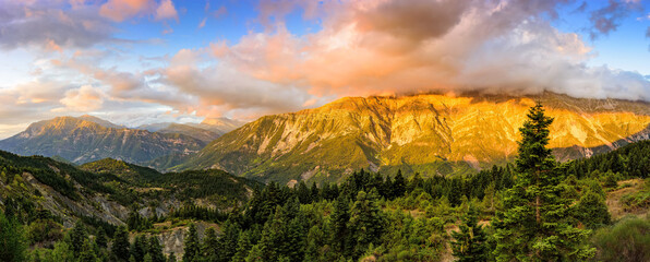 Wide panoramic view of mountains of Tzoumerka National Park in golden hours . Greece