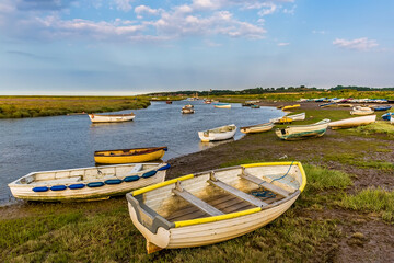 Small boats beached on the banks of the River Glaven, Norfolk