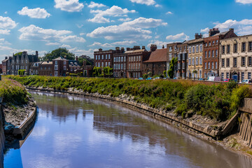 A view across the River Nene towards the North Brink in Wisbech, Cambridgeshire in the summertime