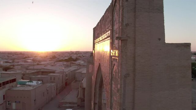Portal of mosque in old Bukhara, Uzbekistan in the rays of the setting sun, drone aerial